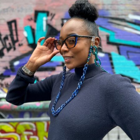 Aura Clarity Nirvana Frame – model wearing FL-41 tinted cat-eye glasses with amber lenses and tortoiseshell arms.Migraine glasses for light sensitivity