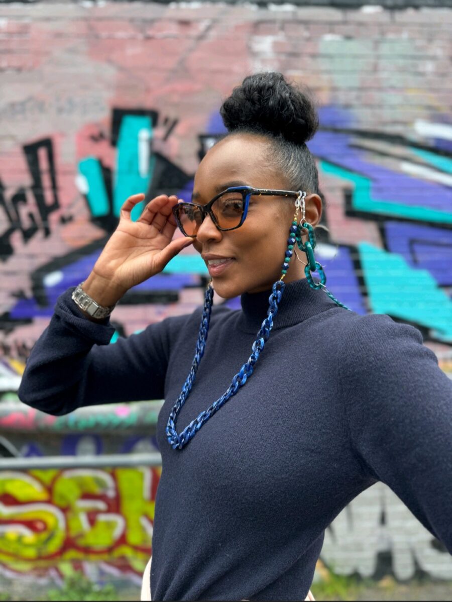 Aura Clarity Nirvana Frame – model wearing FL-41 tinted cat-eye glasses with amber lenses and tortoiseshell arms.Migraine glasses for light sensitivity