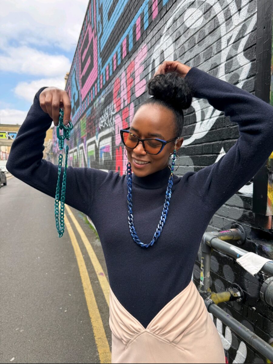 Aura Clarity Nirvana Frame – model wearing FL-41 tinted cat-eye glasses with amber lenses and tortoiseshell arms.Migraine glasses for light sensitivity